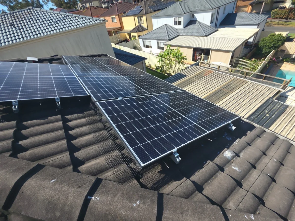 Black bird mesh fitted by Roof & Power Co along a stepped solar panel edge on a tiled roof.